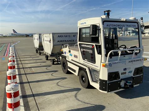 A baggage carrier at an airport Figgerits [ Answers ].